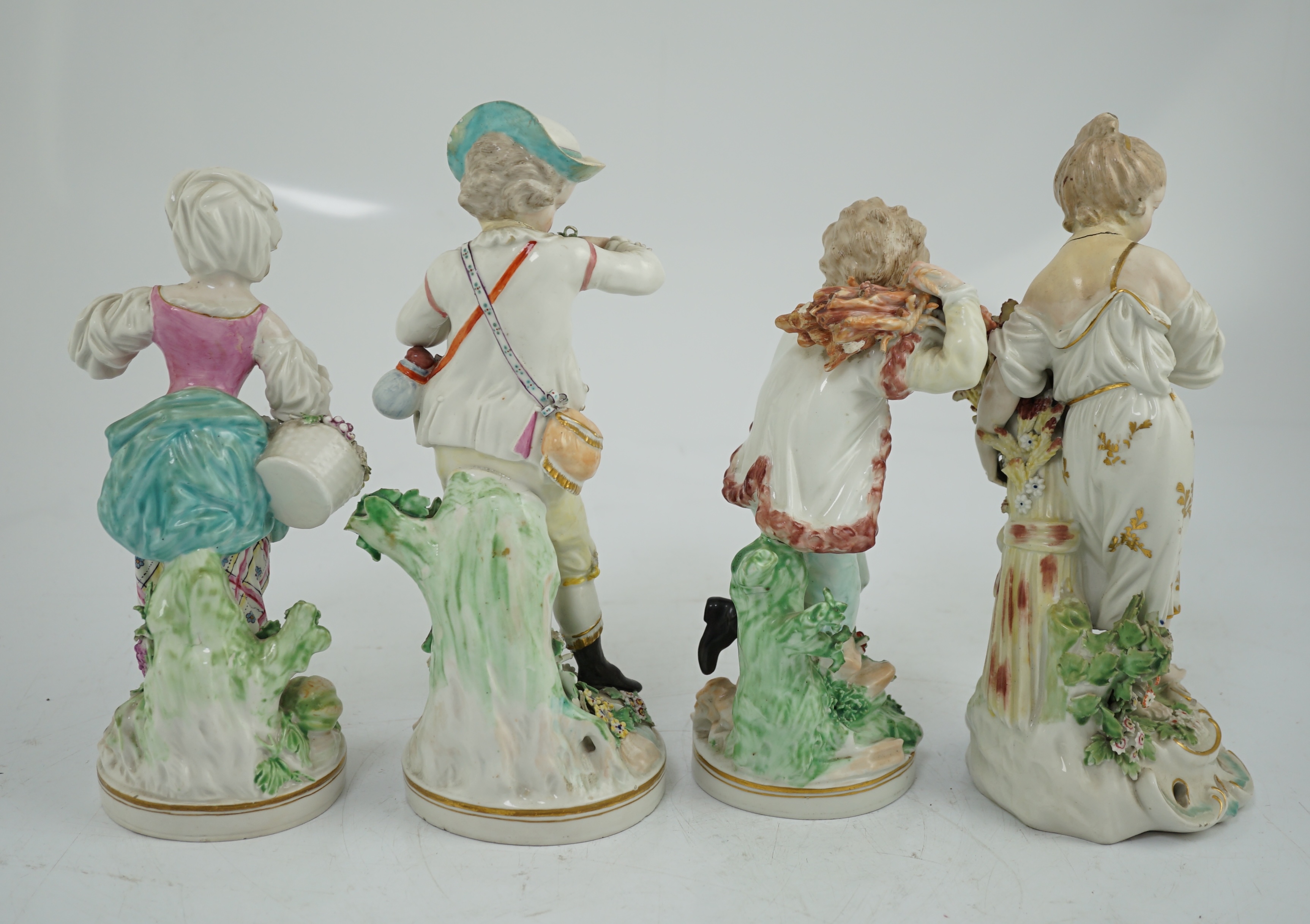 A matched set of four Derby figures emblematic of the Seasons, late 18th century, modelled by Pierre Stephan, the figures of Spring, Summer and Winter on circular bases, the figure of Autumn on a scrollwork base, 21cm to